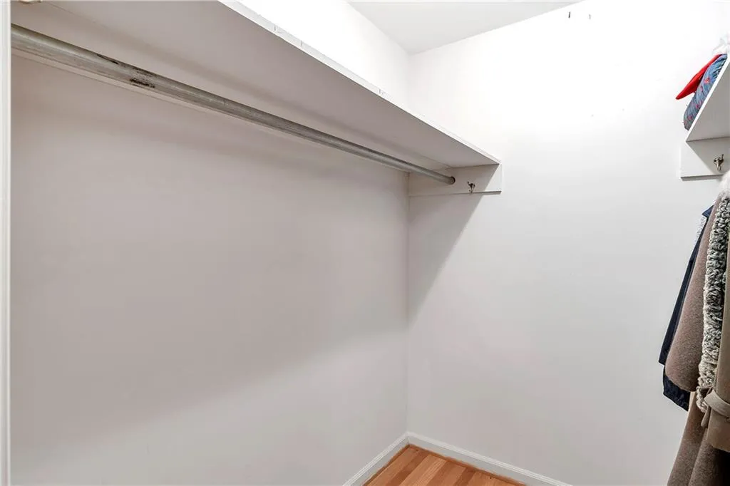 Walk in closet featuring hardwood / wood-style flooring