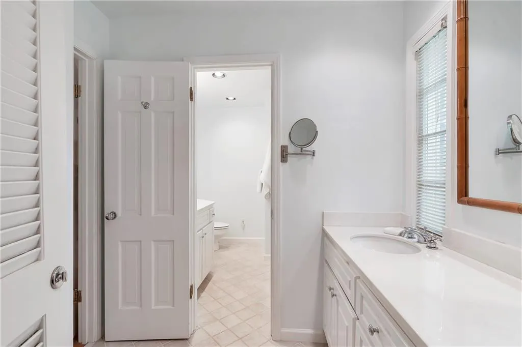 Bathroom featuring tile floors, vanity, and toilet