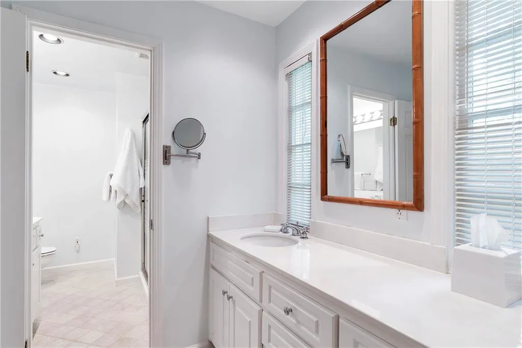 Bathroom with tile flooring, oversized vanity, and toilet