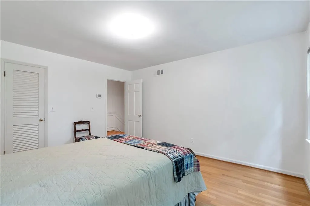 Bedroom with a closet and light hardwood / wood-style floors