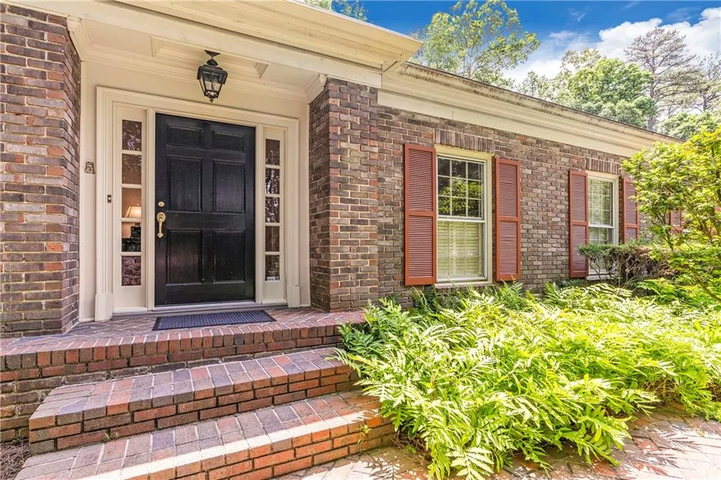 View of exterior entry featuring covered porch