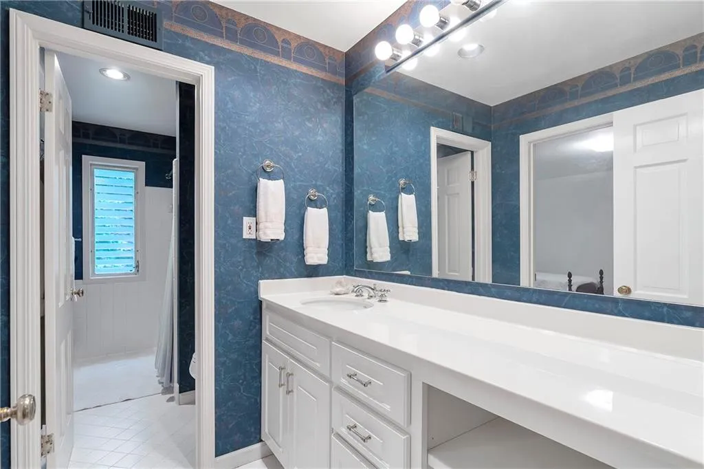 Bathroom with vanity, toilet, and tile floors