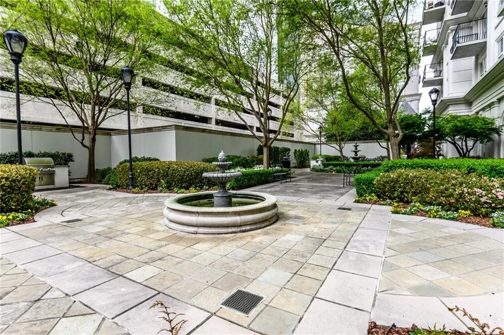 Expansive stone-paved courtyard featuring a central tiered fountain