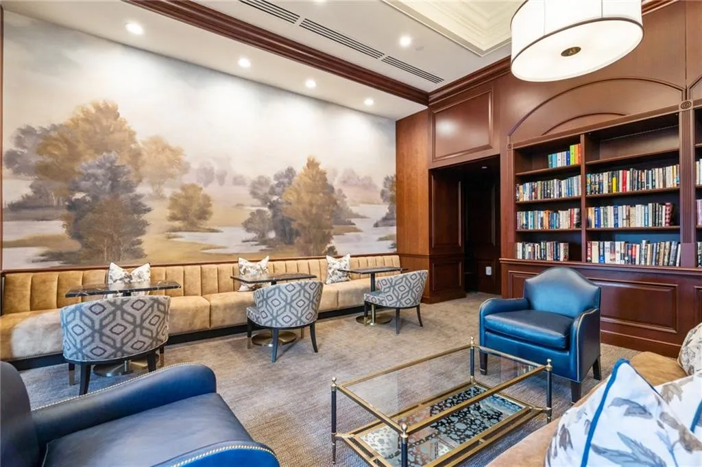 Library room featuring extensive built-in mahogany shelving, a large landscape mural, recessed lighting, and crown molding