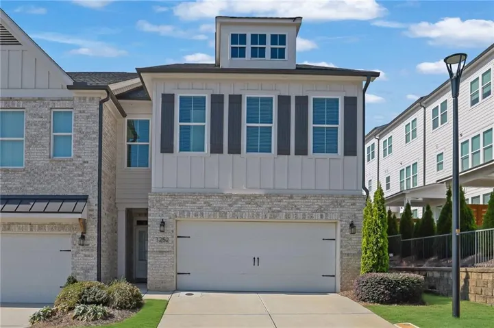 Brick and board-and-batten exterior with a two-car garage