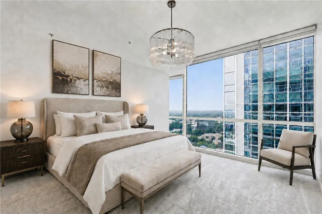 VIRTUALLY STAGED-Expansive floor-to-ceiling windows, contemporary chandelier, plush carpet flooring, and custom window treatments