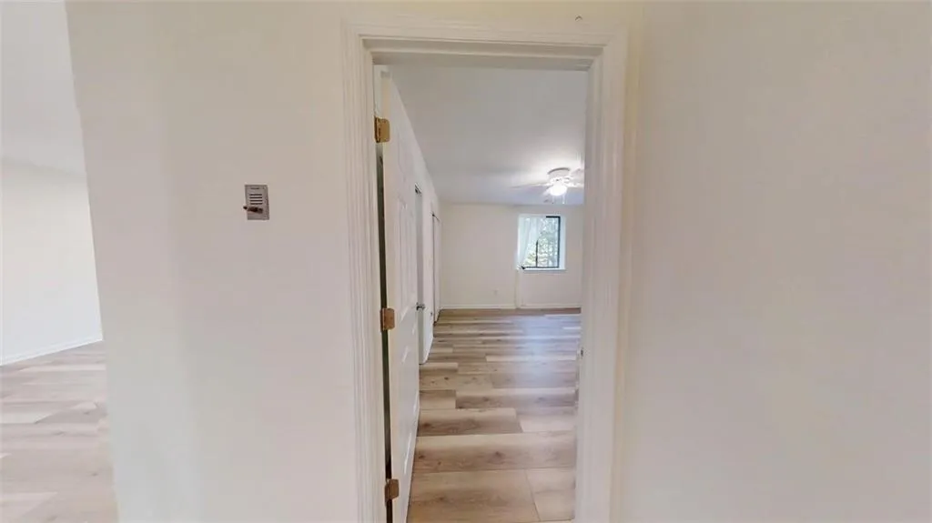Hallway featuring light wood-style floors and baseboards