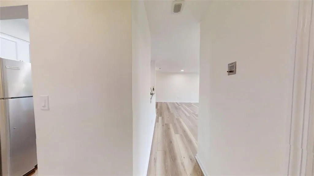 Hallway featuring light wood-style floors and recessed lighting