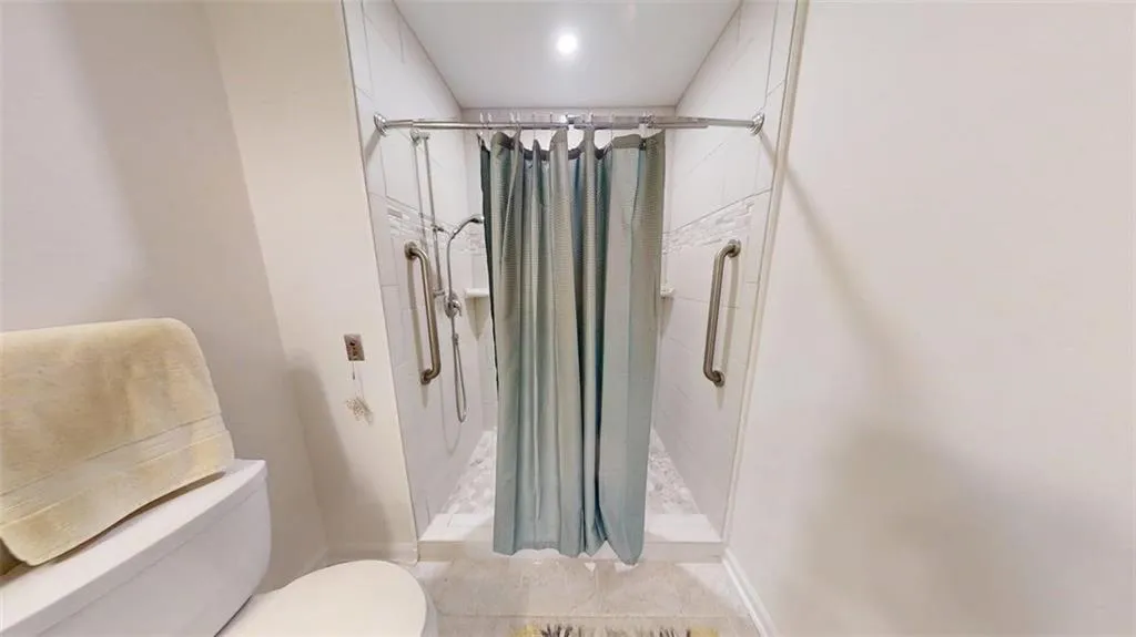 Bathroom with toilet and a stall shower