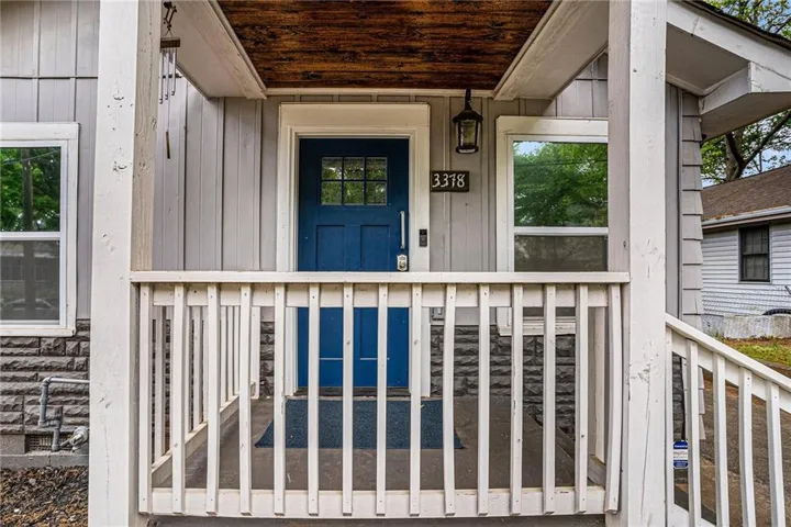 Covered front porch with wood-finish ceiling