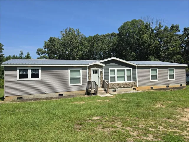 Gray siding exterior with a metal roof