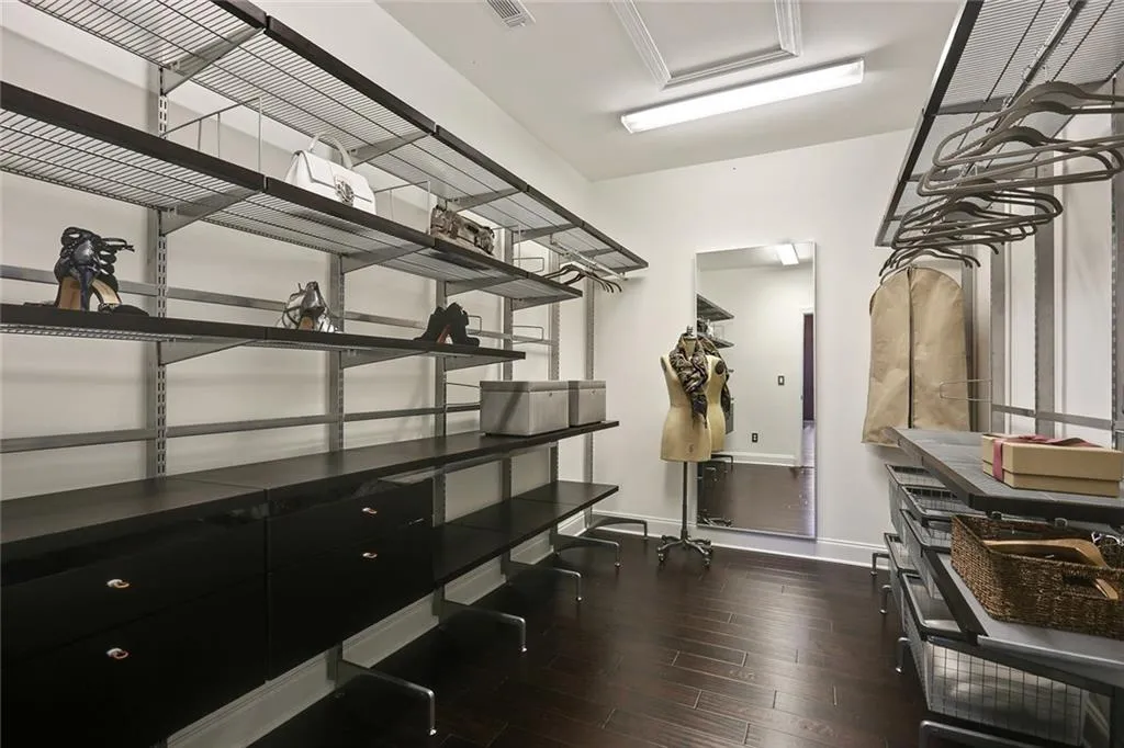 Generous sized walk-in closet with custom closet system.