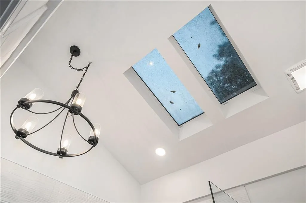Detailed view of recessed lighting and a chandelier