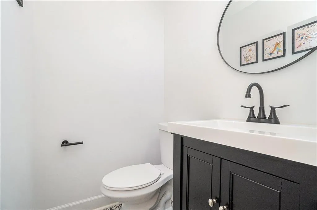 Half bath with vanity and baseboards