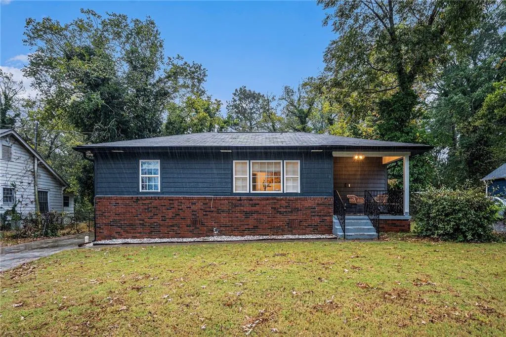 View of front of home featuring a front yard and a porch