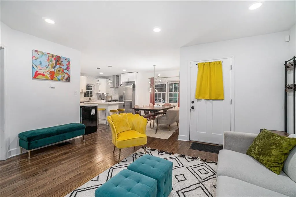 Living room featuring dark wood-style flooring and recessed lighting