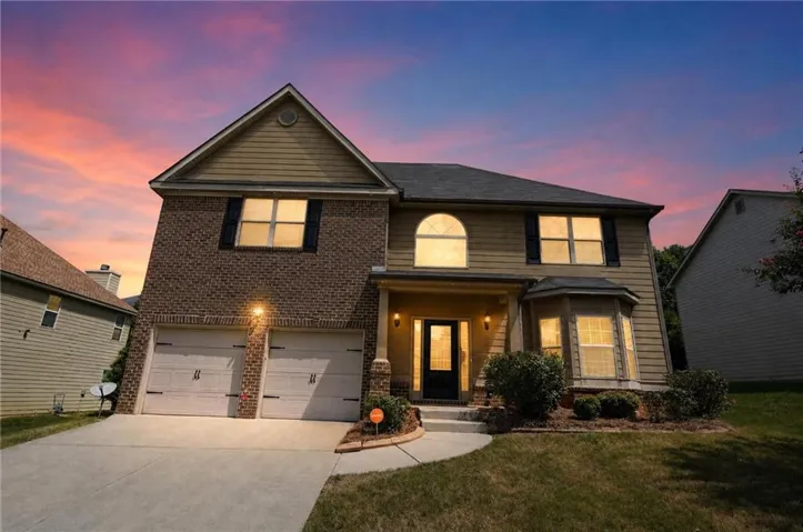 Brick and siding exterior with a two-car garage