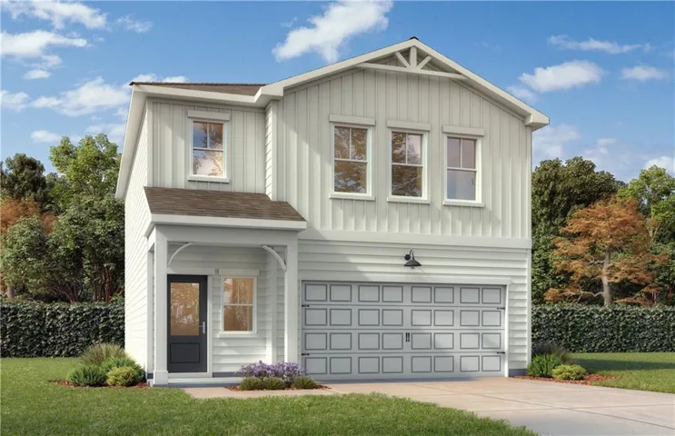 Modern two-story residence featuring a covered entry porch, dark-paneled main door with glass insert, attached two-car garage, and horizontal siding details