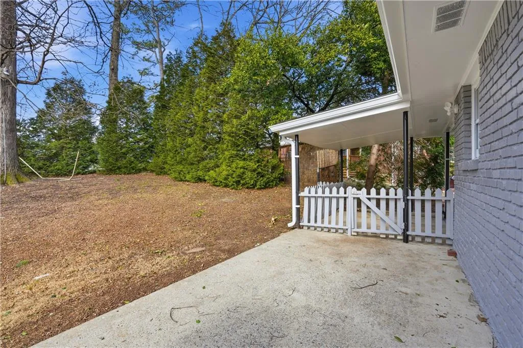 View of yard with a patio area and a gate