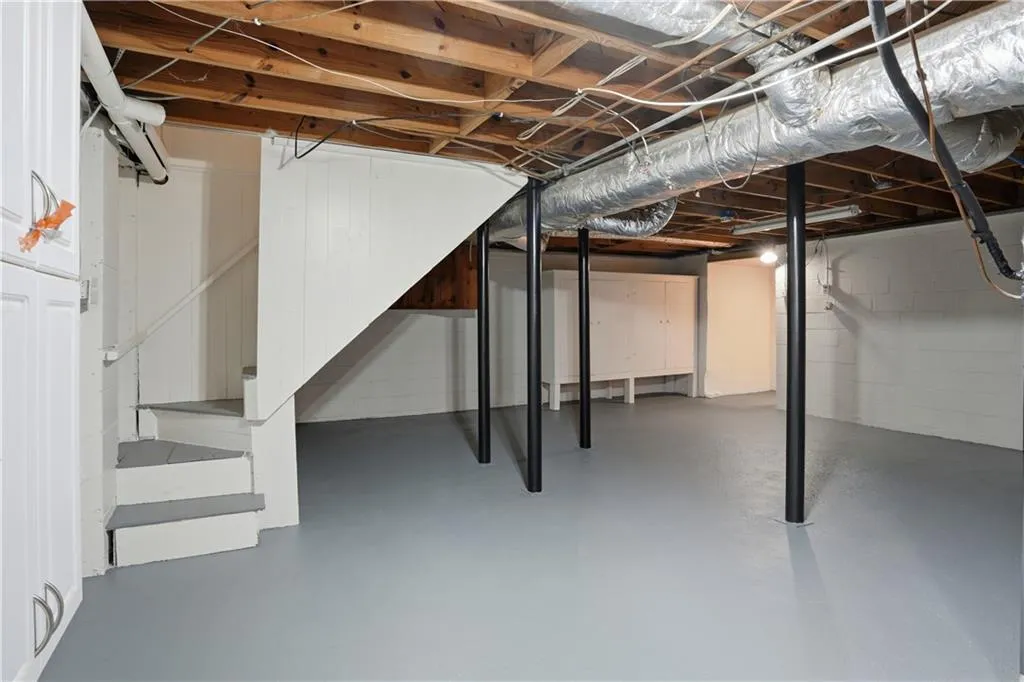 Unfinished basement featuring stairway