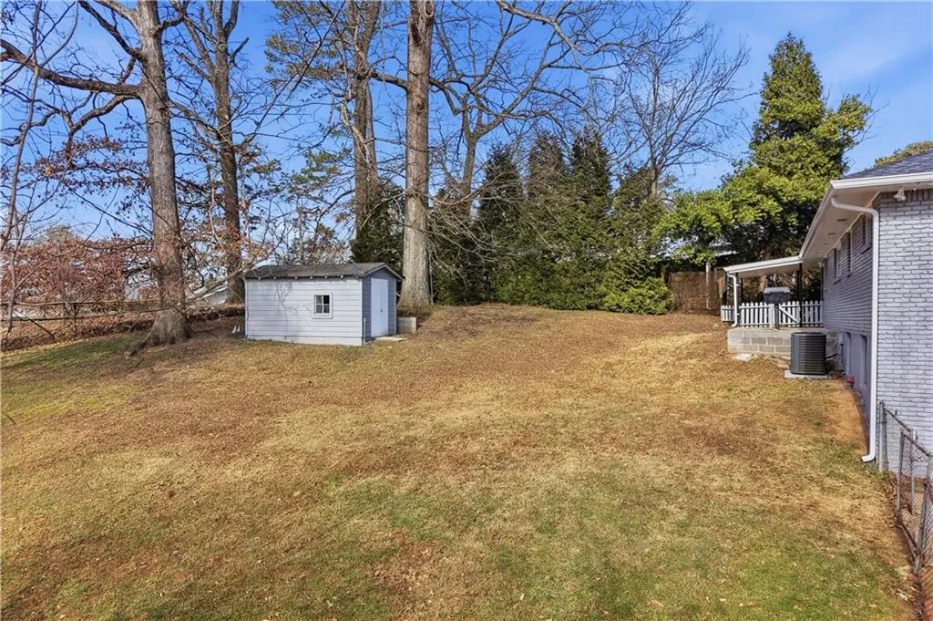 Fenced backyard with a shed/storage unit