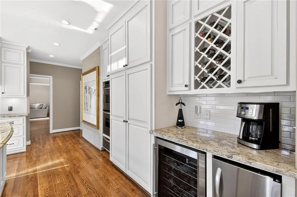 Butlers area with a wine cooler and ice maker