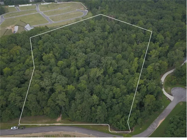Aerial view of property and surrounding area with property parcel outlined