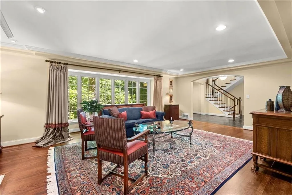 Living room featuring ornamental molding and hardwood / wood-style floors