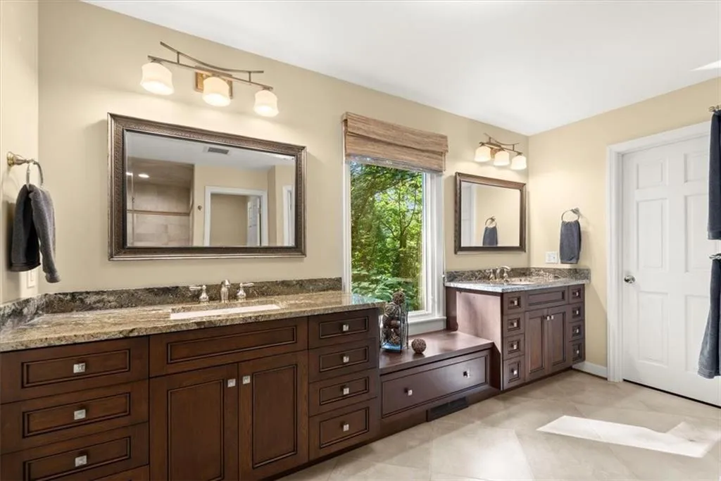 Bathroom with dual bowl vanity and tile floors