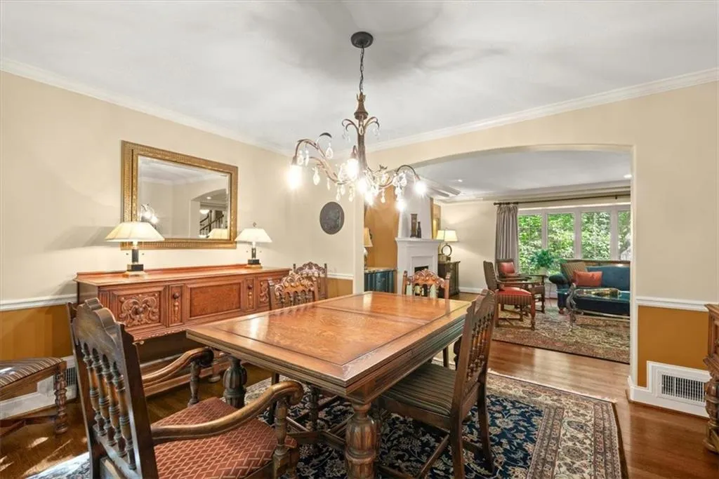 Dining space featuring a chandelier, ornamental molding, and wood-type flooring