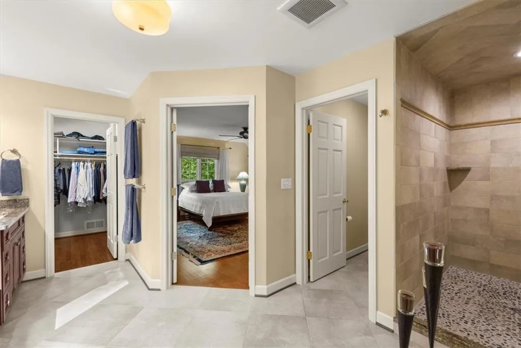 Bathroom featuring ceiling fan, tile flooring, and vanity