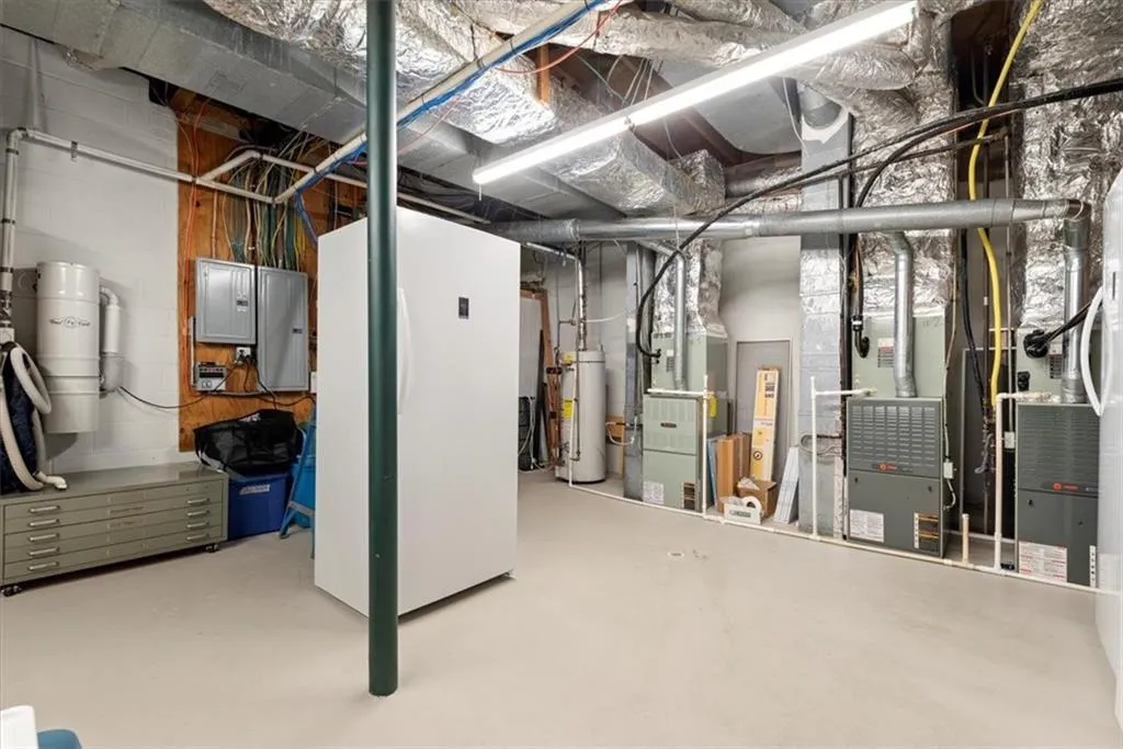 Basement featuring water heater and heating utilities