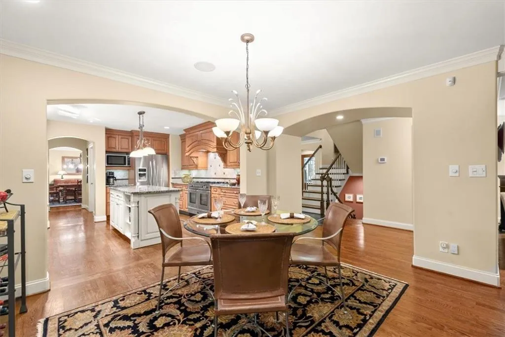 Dining space featuring light hardwood / wood-style flooring, crown molding, and an inviting chandelier