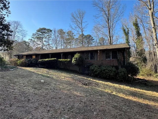 Ranch-style house featuring brick siding