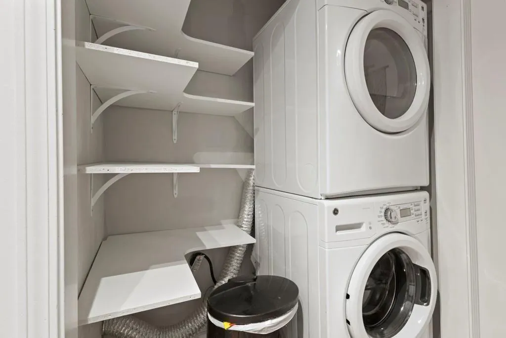 Laundry area featuring stacked washer and dryer an