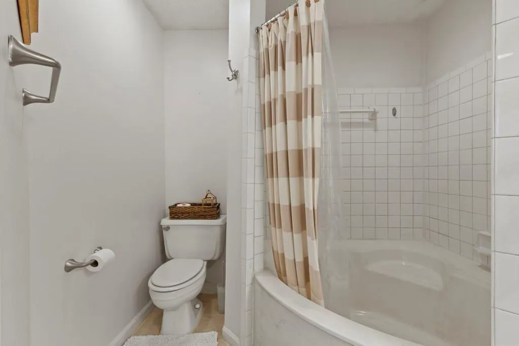 Bathroom featuring baseboards, shower / bath combi