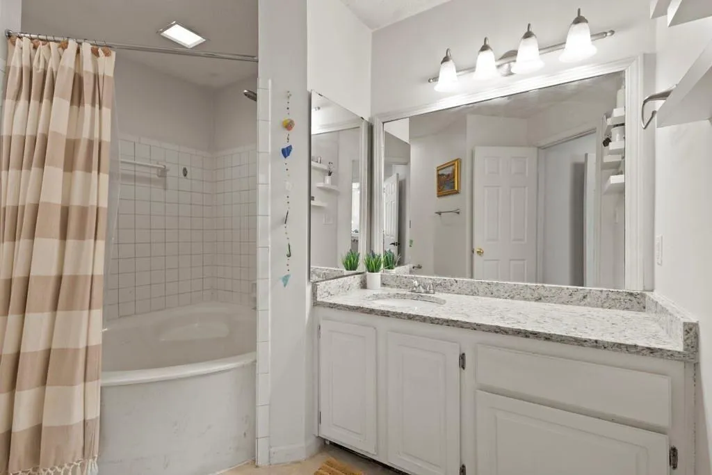 Full bath featuring vanity and shower / tub combo