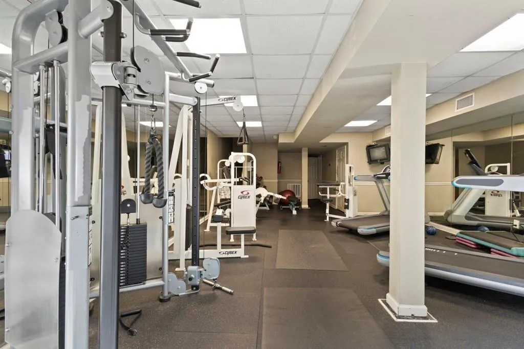 Gym with a paneled ceiling and visible vents