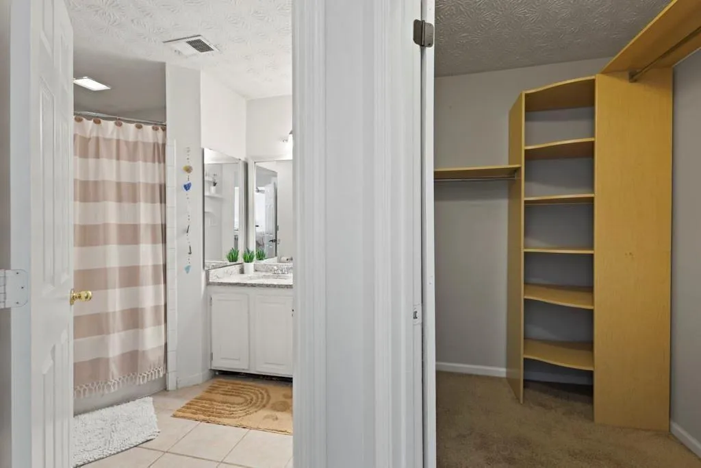 Full bathroom with a shower with curtain, visible