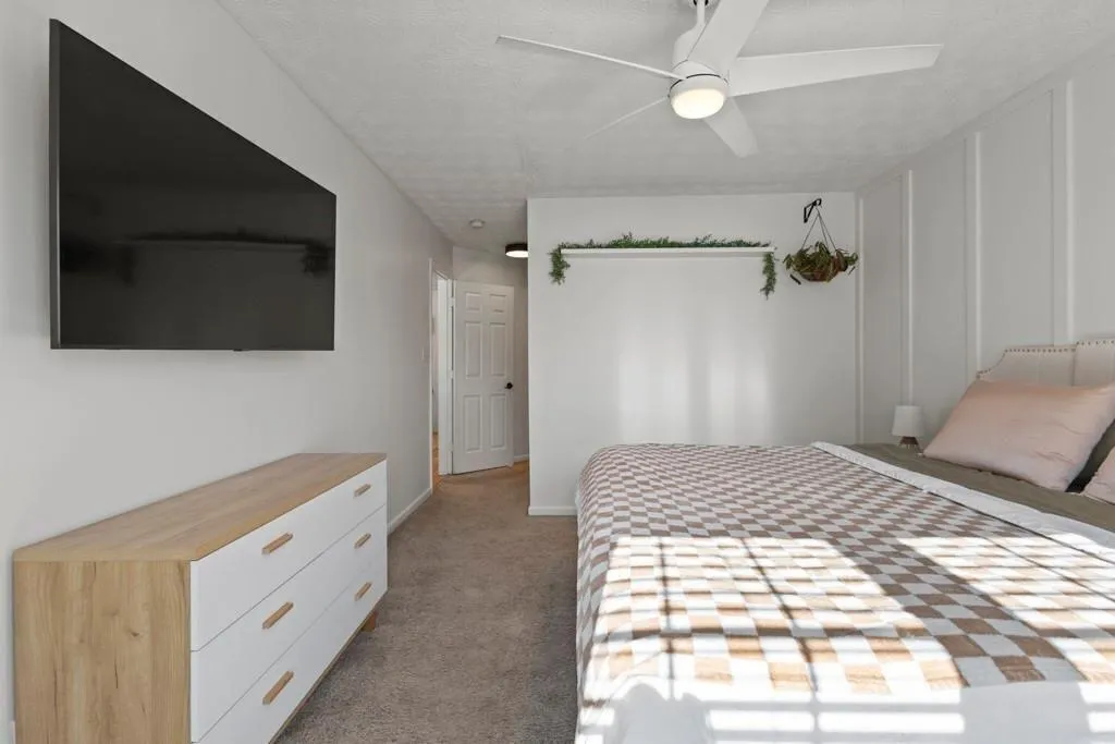 Unfurnished bedroom with light carpet, a ceiling f
