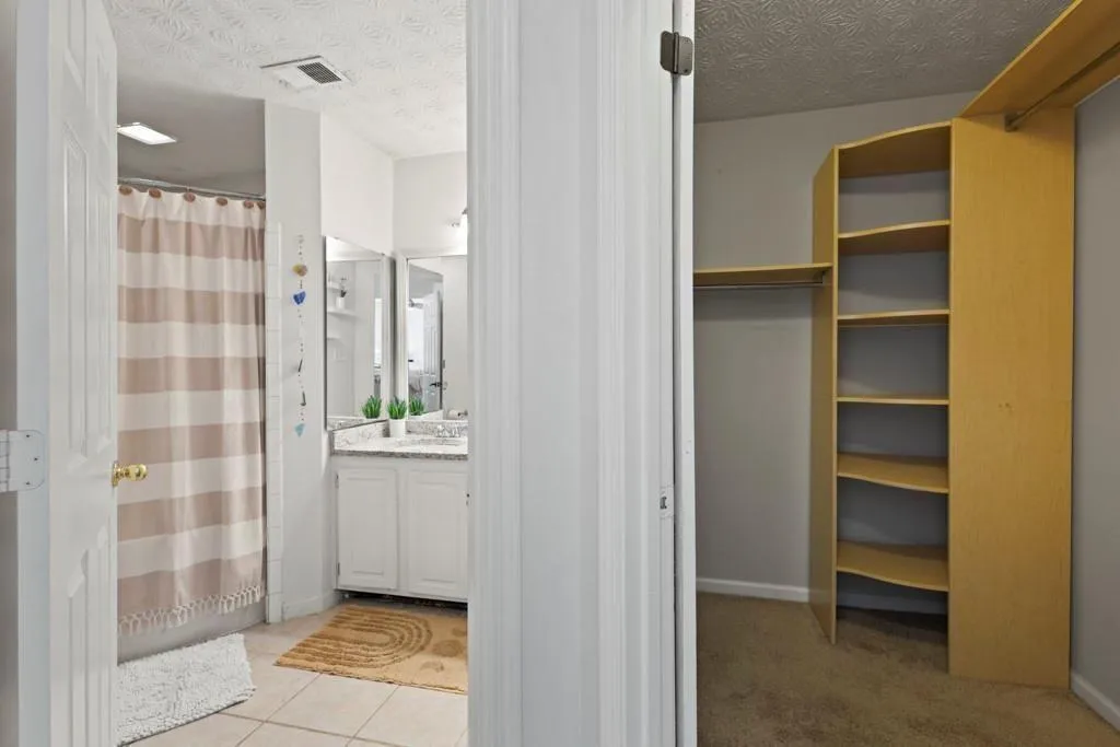 Full bathroom with a shower with curtain, visible
