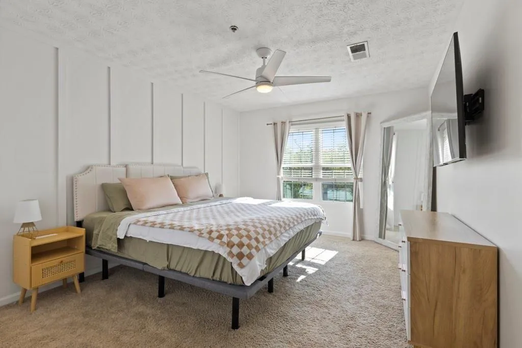 Bedroom featuring a ceiling fan, visible vents, a