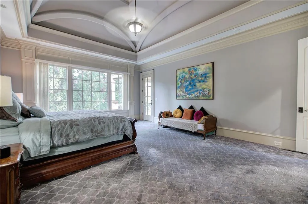 Bedroom with ornamental molding, vaulted ceiling, access to exterior, and carpet floors