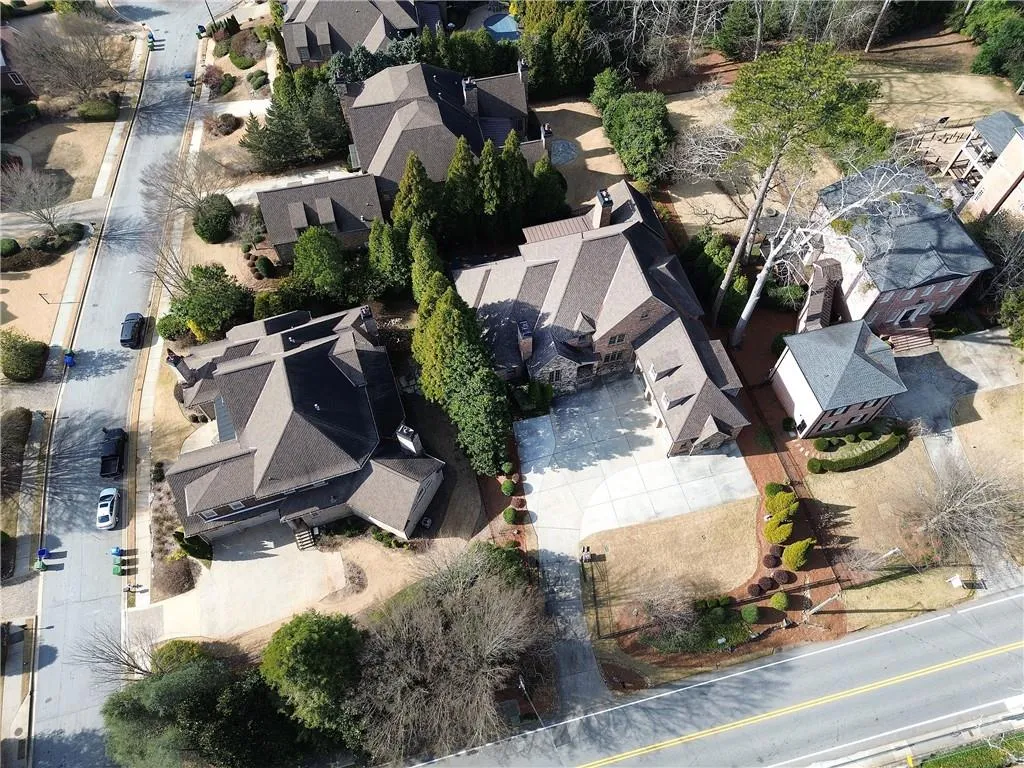Aerial view of property and surrounding area with nearby suburban area