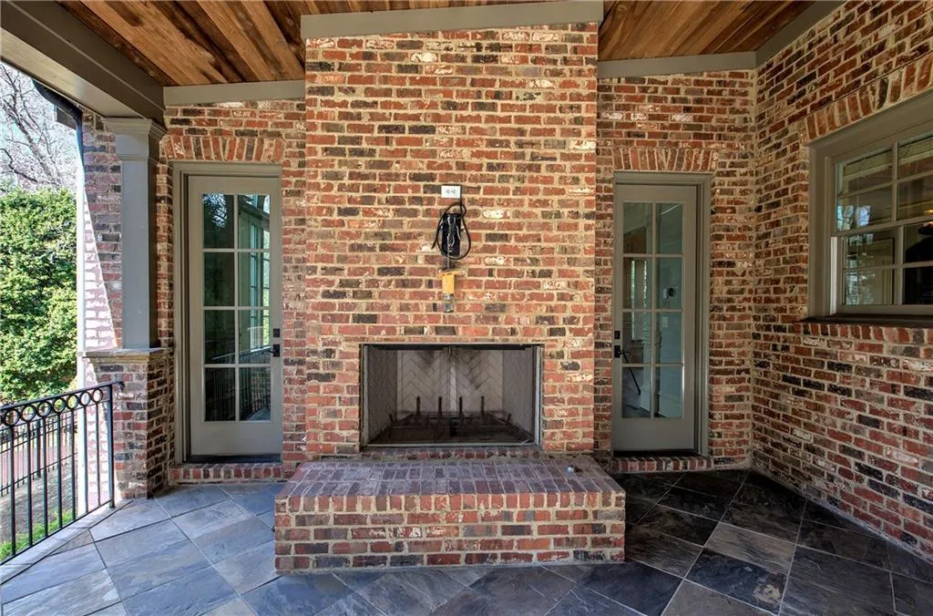 View of patio / terrace featuring an outdoor brick fireplace