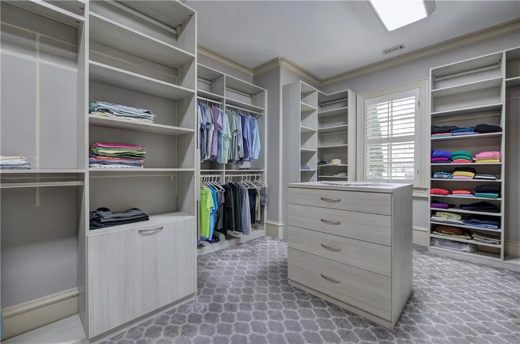 Walk in closet with light carpet