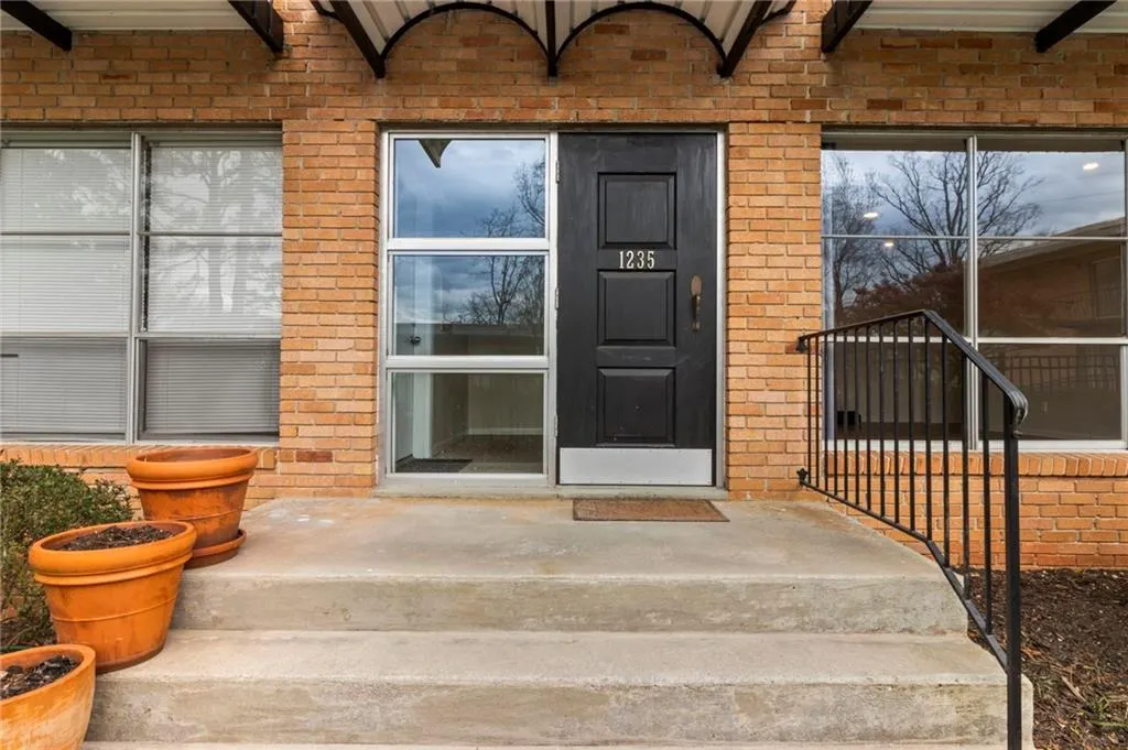 Property entrance featuring brick siding
