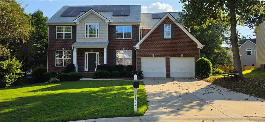 Brick exterior with gabled roofline and solar panels