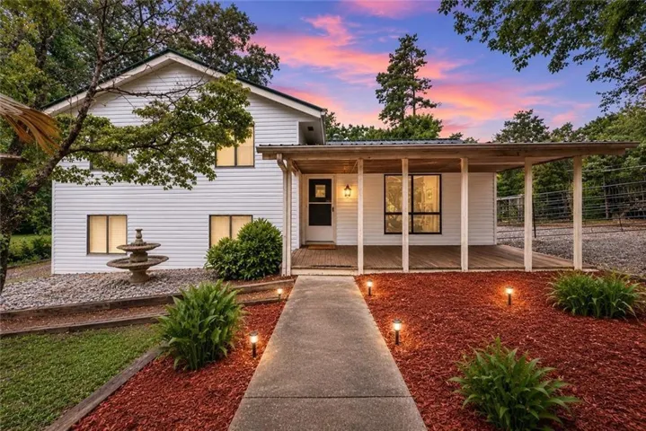 White siding exterior with a covered porch