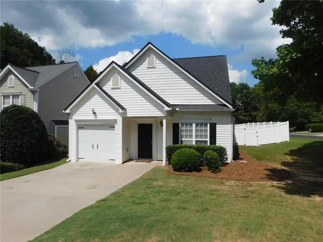 White vinyl siding exterior with dark asphalt shingle roof